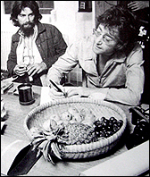 John Lennon at the kitchen table of his Tittenhurst mansion during the recording session for the Imagine album. Former Beatle, George Harrison, is sitting to the right of Lennon.