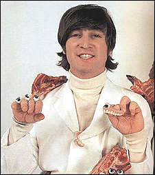 John Lennon clowns around with some props at the Butcher Cover photo session.