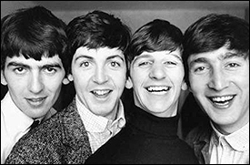 The Beatles realize that four heads are better than one in this delightful photo taken sometime in 1963.