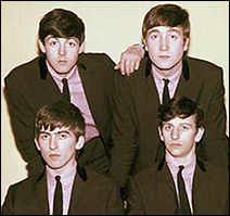Looking a bit like a group mugshot, The Beatles pose for a quick photo in 1963.