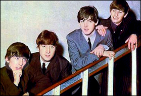 The Beatles pose on a flight of stairs, circa 1964.