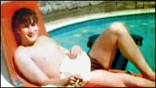 John Lennon sunbathes in a seaside resort in 1965.