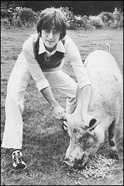 John Lennon poses with a pig, making fun of Paul McCartney's Ram album cover (where Paul posed with a ram).