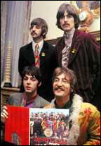 The Beatles pose with their new album, Sgt. Pepper's Lonely Hearts Club Band, at a press party given at Brian Epstein's home in London, England.